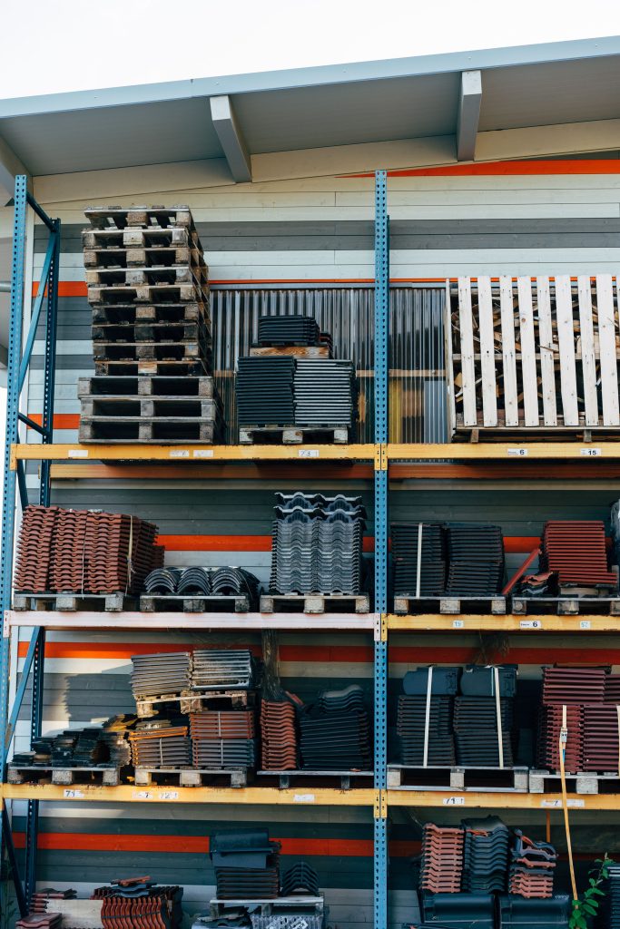 pexels-photo-10261153-10261153 Neatly stacked building materials in a warehouse setting, showcasing construction organization.